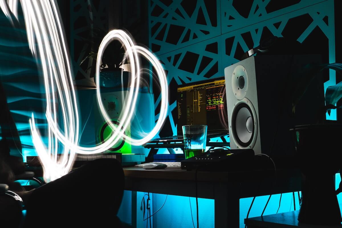 Making music on computer with green lights. Source: Unsplash