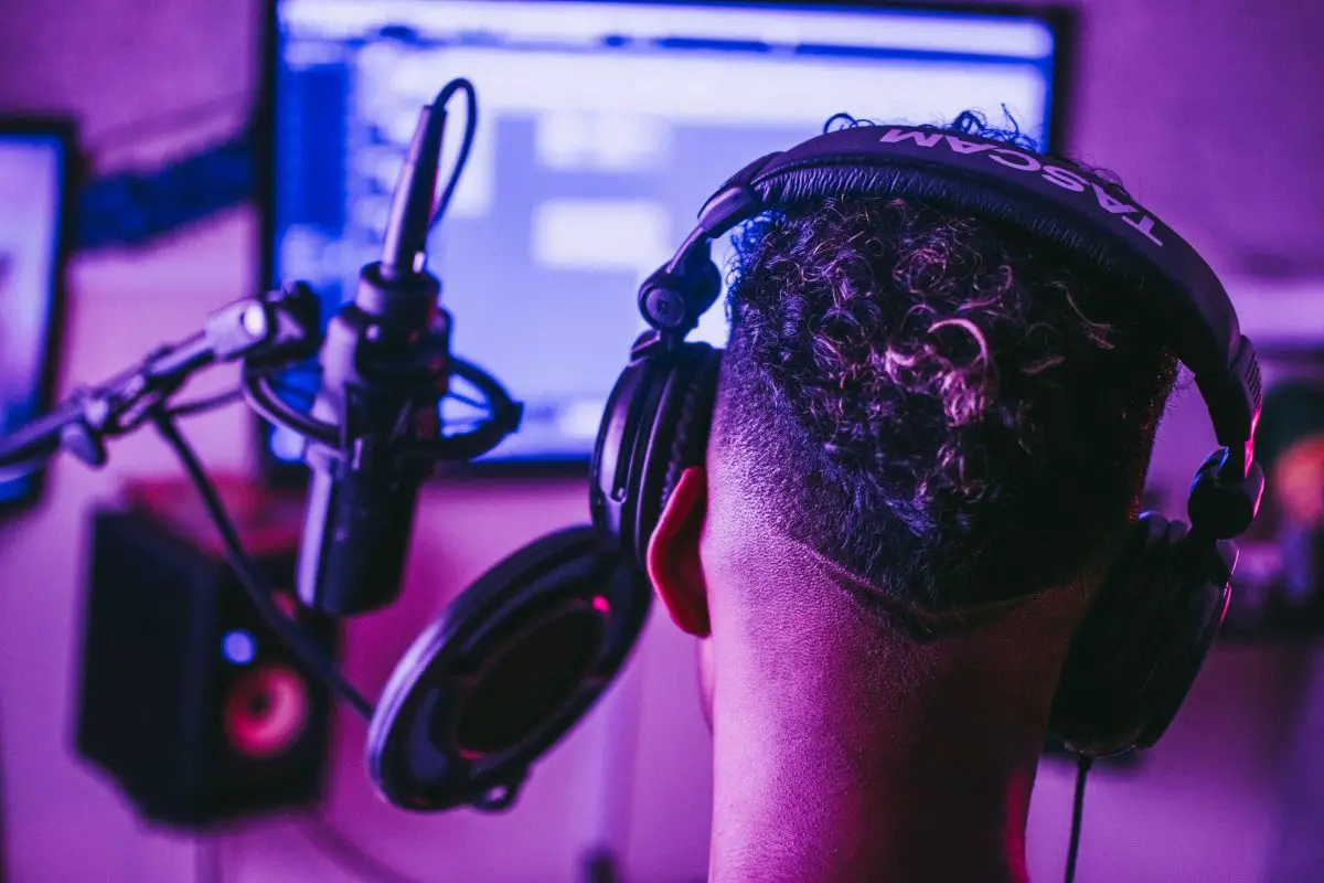 Image of a young man in a recording studio wearing headphones davis sa nchez pexels