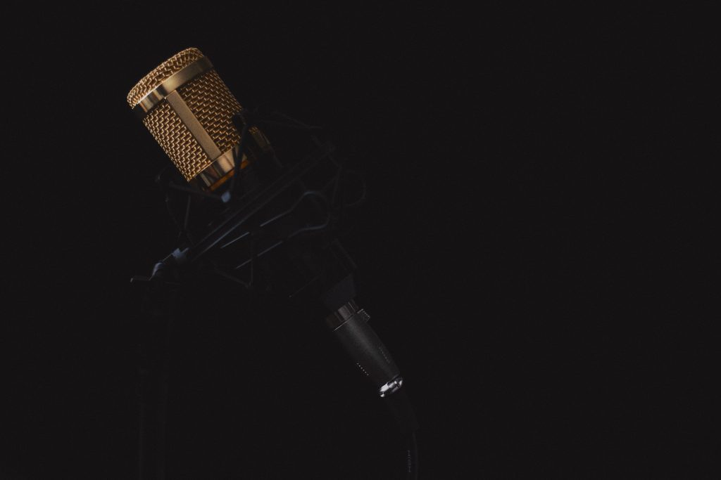 Image of a gray and black colored microphone on a stand. Source: hrayr movsisyan, pexels