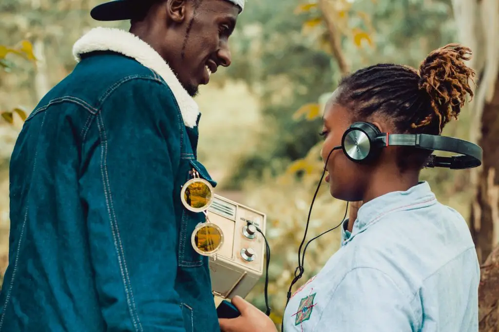 Image of a man and a woman wearing a headphone while lkistening music on a radio. Source: nicholas githiri, pexels