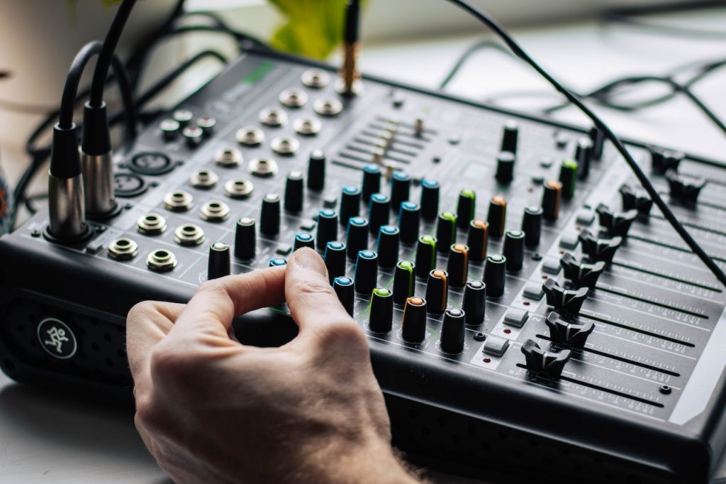 Image of someone's hand using a midi device. Source: layla yehia, pexels