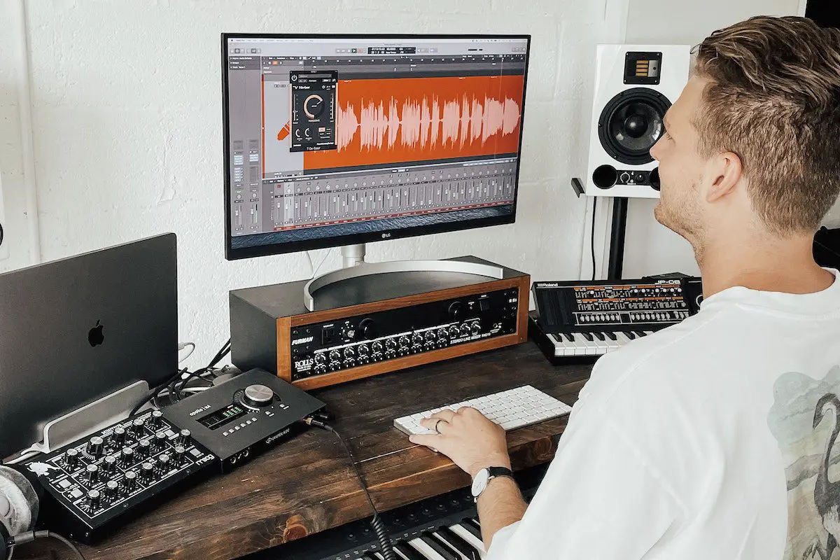 Man working on a home recording studio. Source: techivation, unsplash