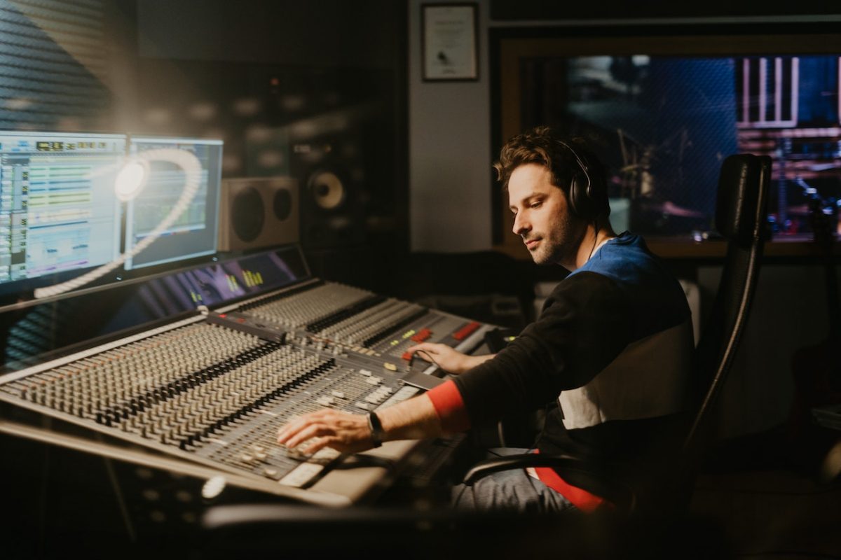 Image of a man with a headphone, while editing sound effects. Source: tima miroshnichenko, pexels