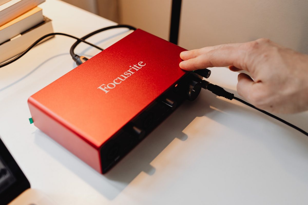 Image of a red audio interface on a desk. Source: karolina grabowska, pexels