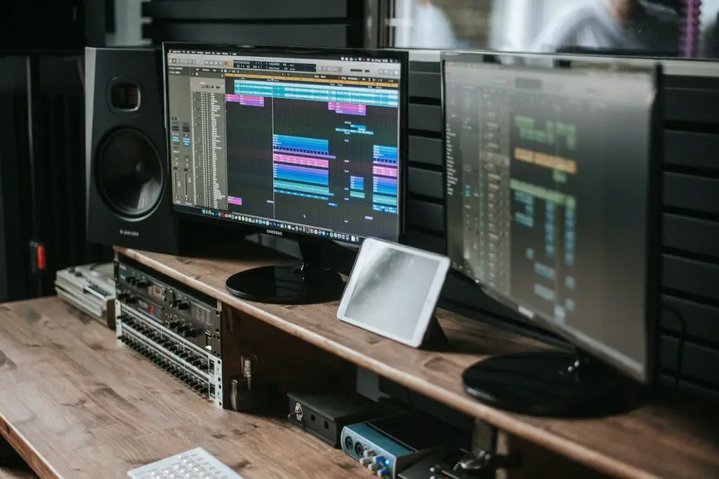 Image of a studio monitor, a speaker and other recording equipment. Source: John Wolf, Pexels