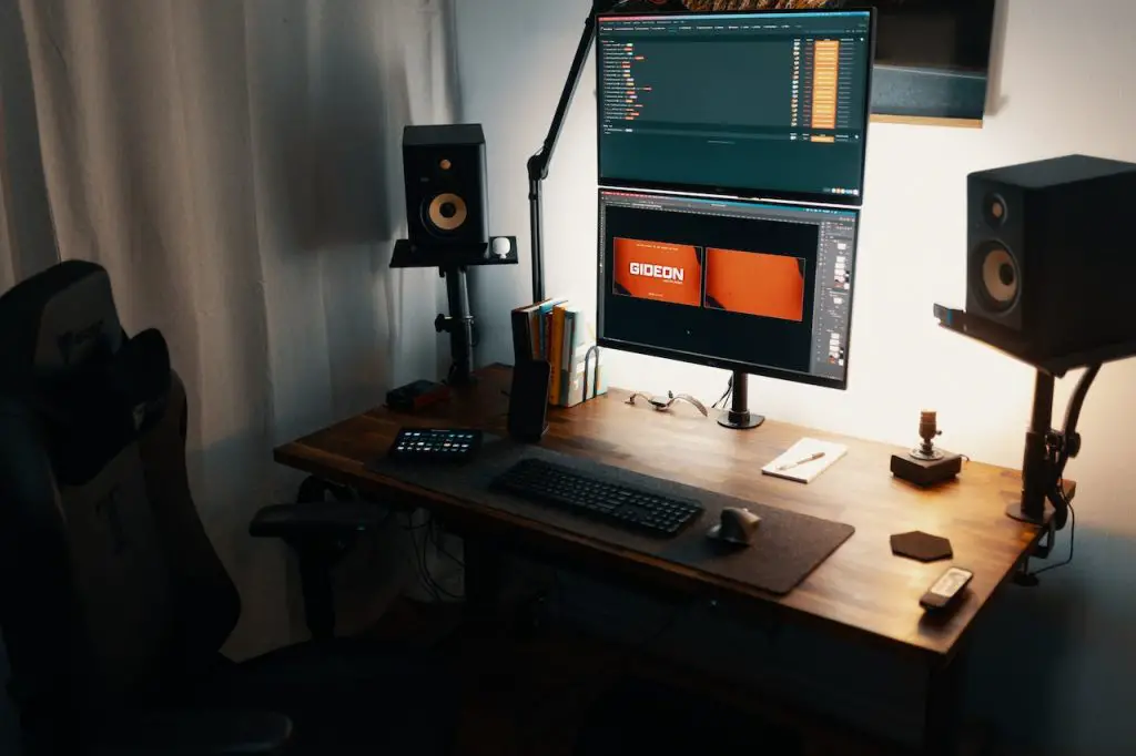 Image of a studio monitor with speakers beside it. Source: josh sorenson, pexels