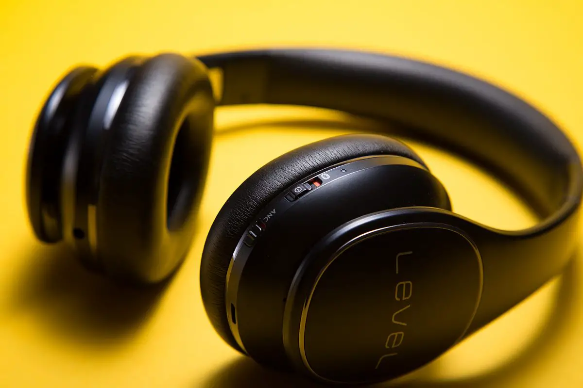 Image of black bluetooth headphones on yellow backdrop. Source: cdx, unsplash