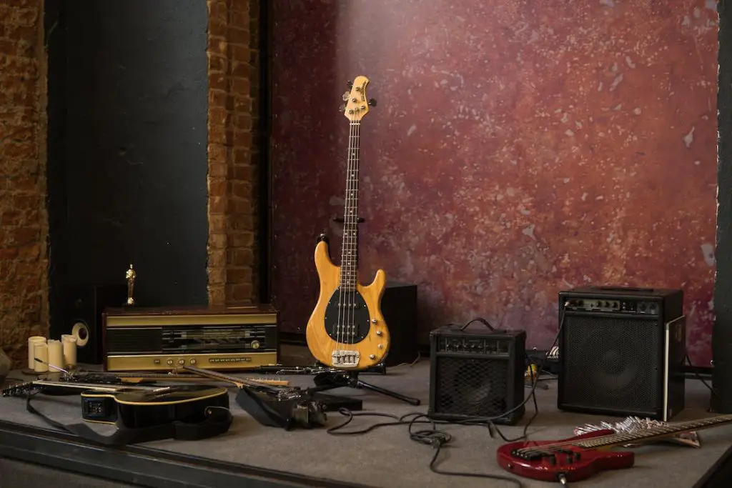 Image of guitars and amplifiers on top of a mini stage. Source: pexels