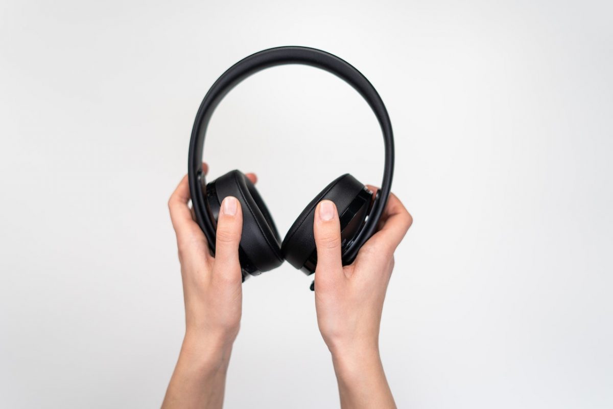 Image of someone holding a black headphones. Source: cottonbro studio, pexels