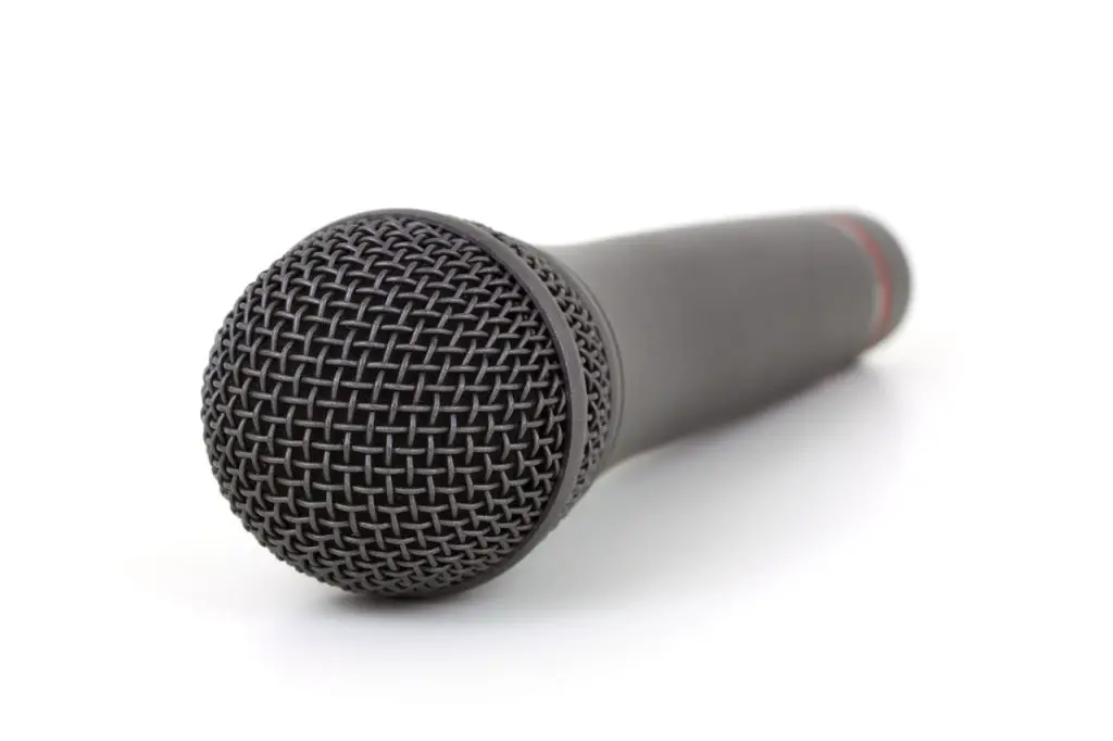 Image of a black microphone on a white surface. Source: Public Domain Pictures, Pexels