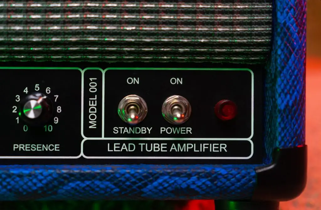 Image of a blue amplifier showing the power an stanby button. Source: alena sharkova, pexels
