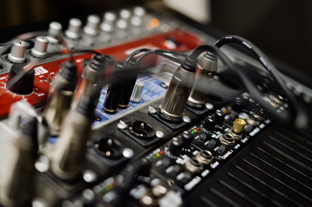 Image of speaker cable wires connected in an audio mixer. Source: magstd, pexels