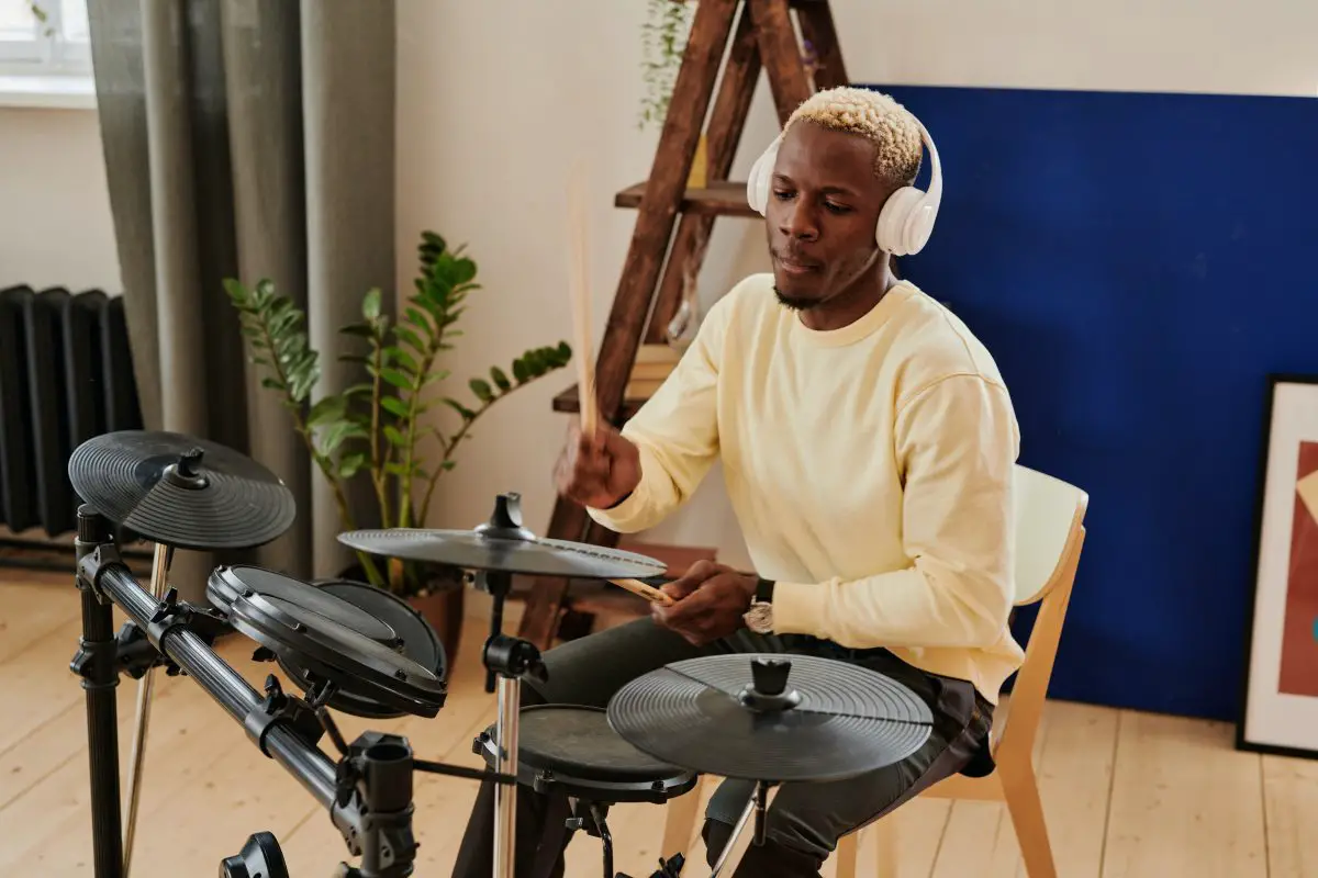 Image of a man playing electronic drums. Source: pexels