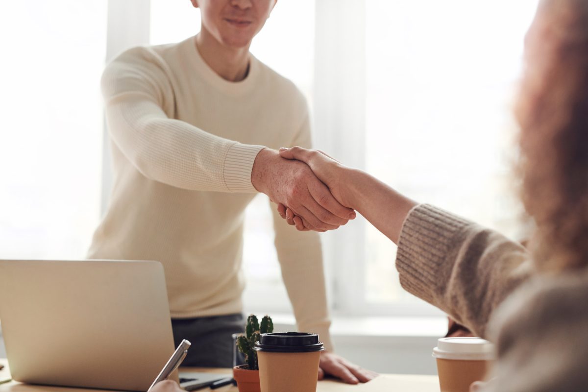 Man shaking hands with a woman. Source: Pexels