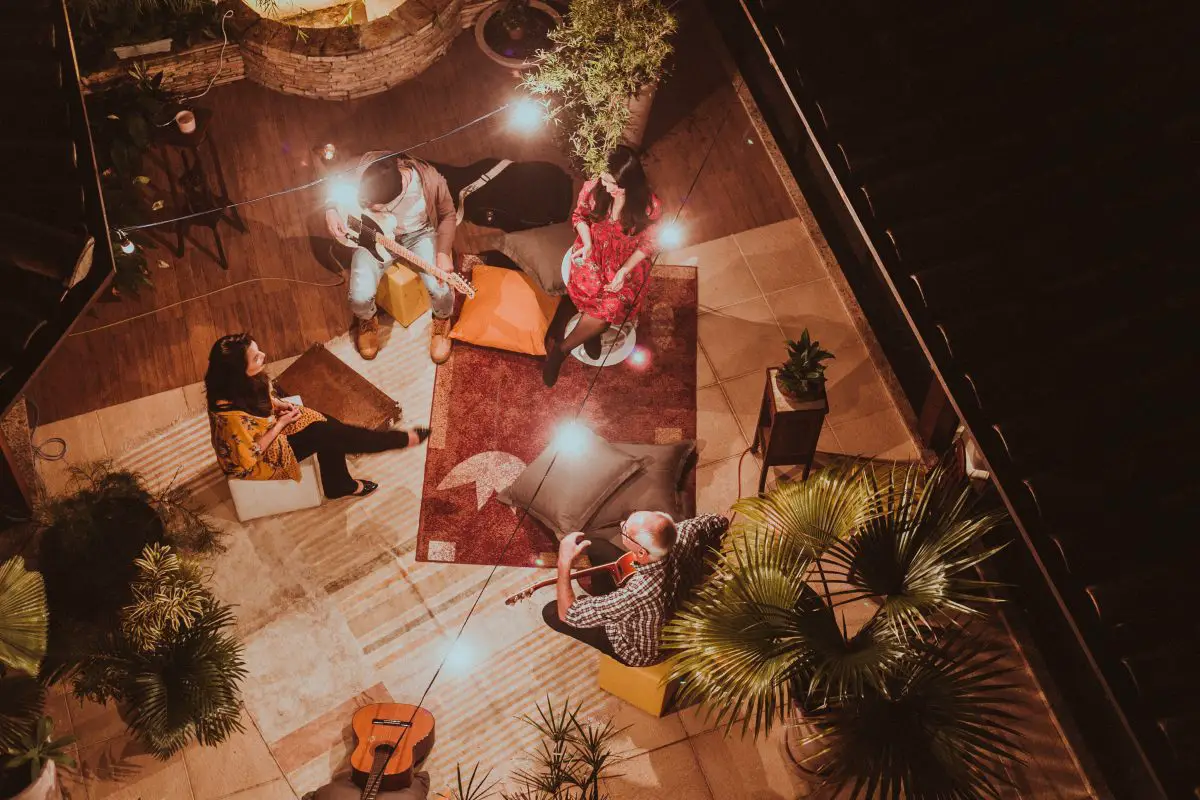 Image of a group of music enthusiast having a jam session on a rooftop. Source: pexels