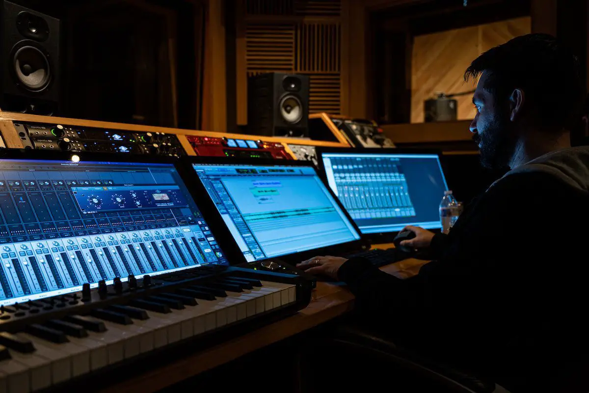 Image of a man working in a recording studio. Source: pexels
