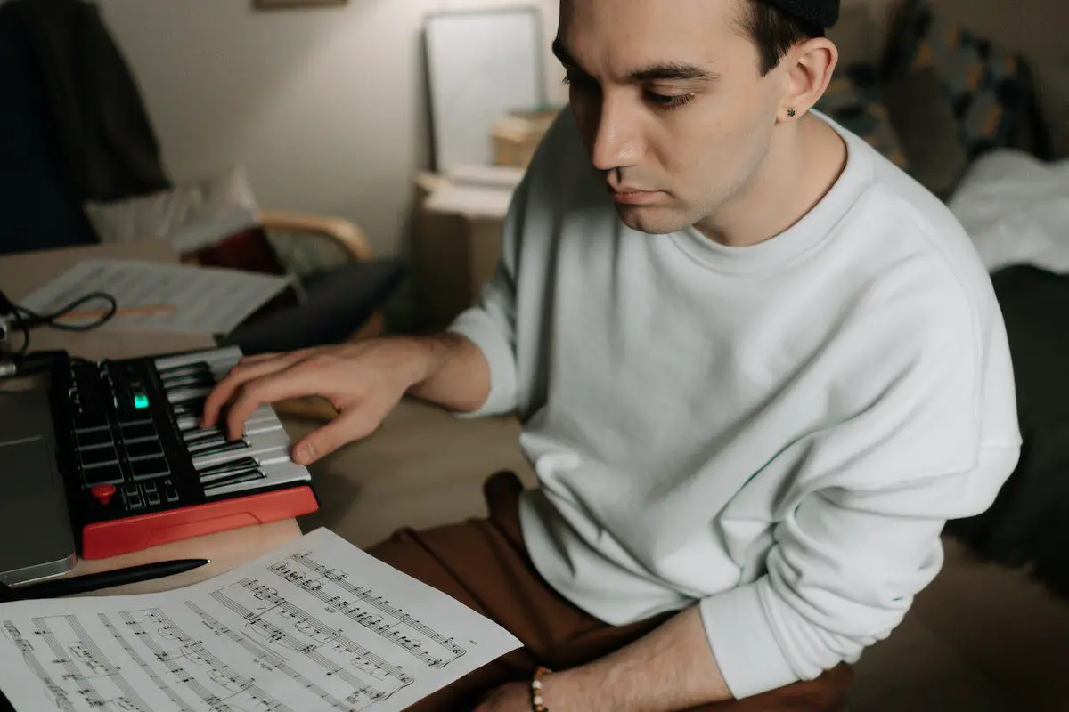 Image of a musician reading a music sheet pexels