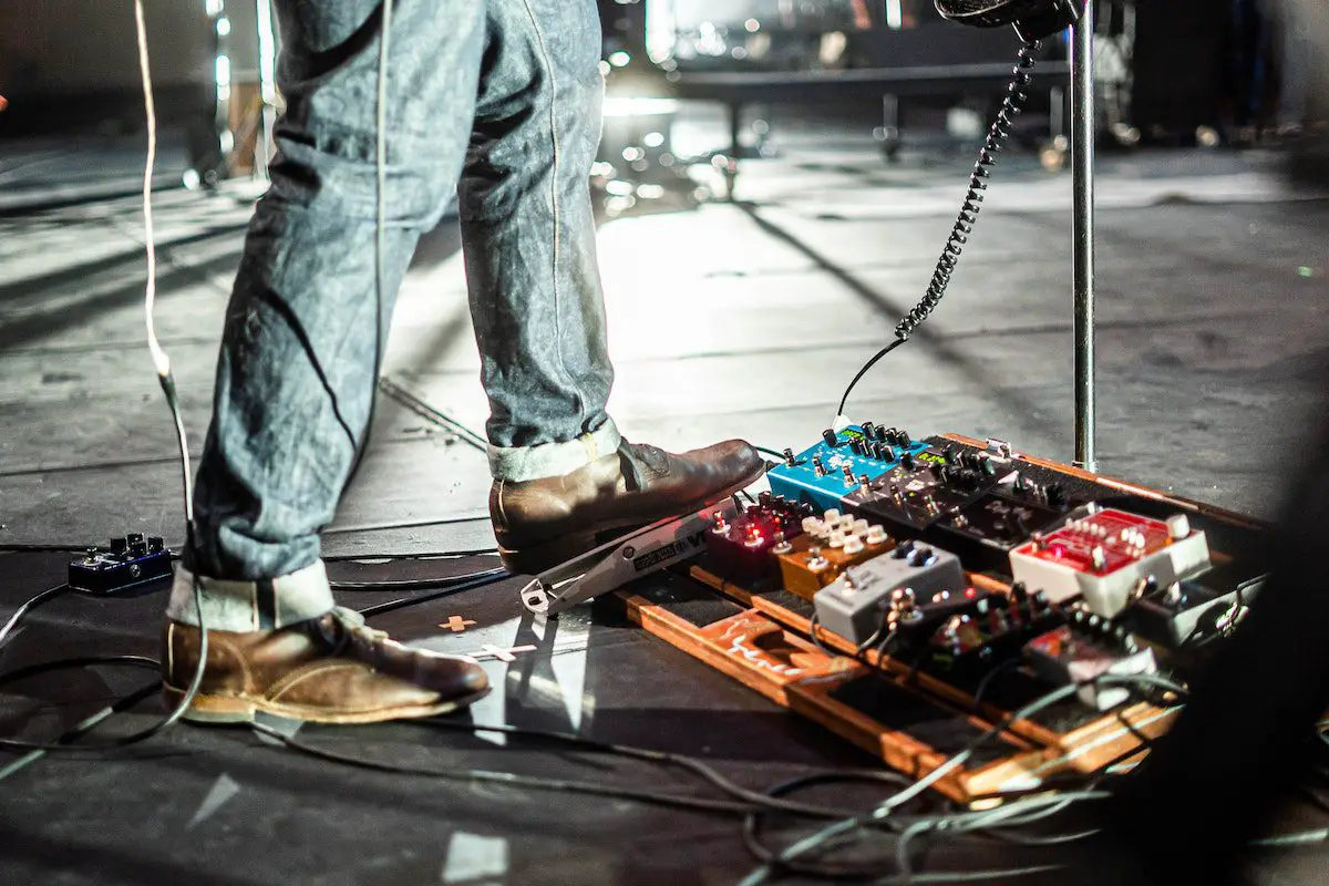 Image of a musician using a pedalboard. Source: pexels