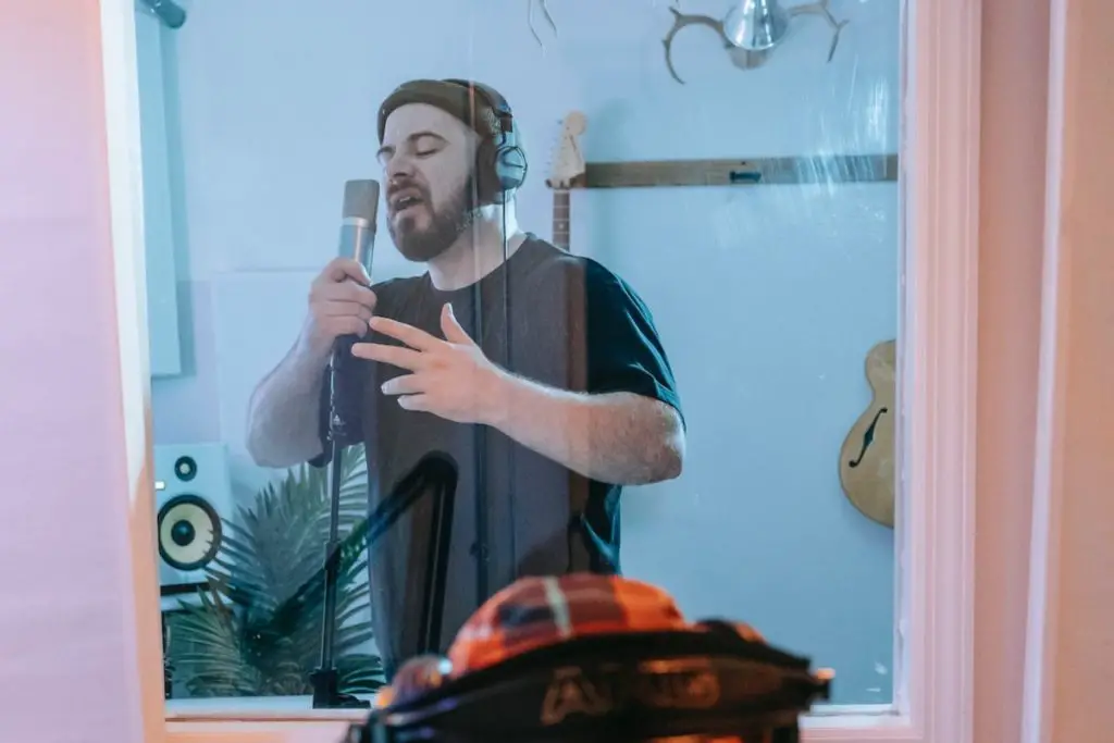 Image of a singer in an isolation booth. Source: pexels
