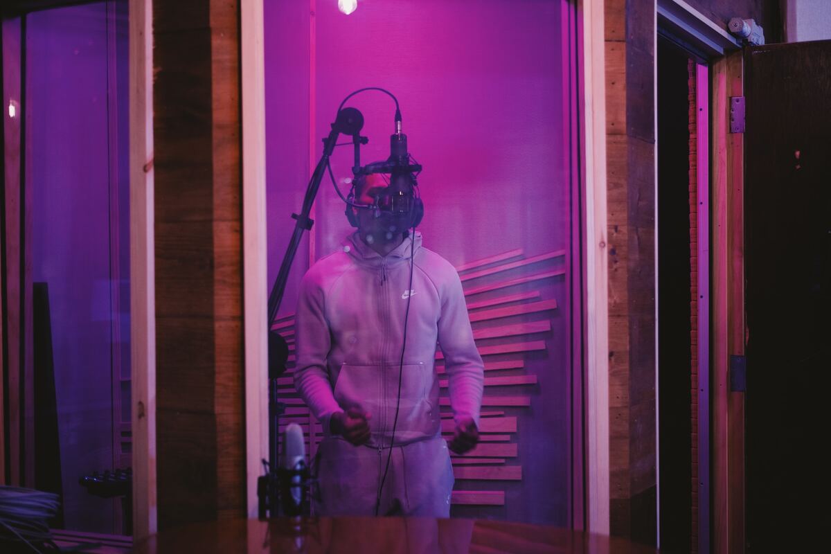 Image of a singer recording in a studio. Source: unsplash