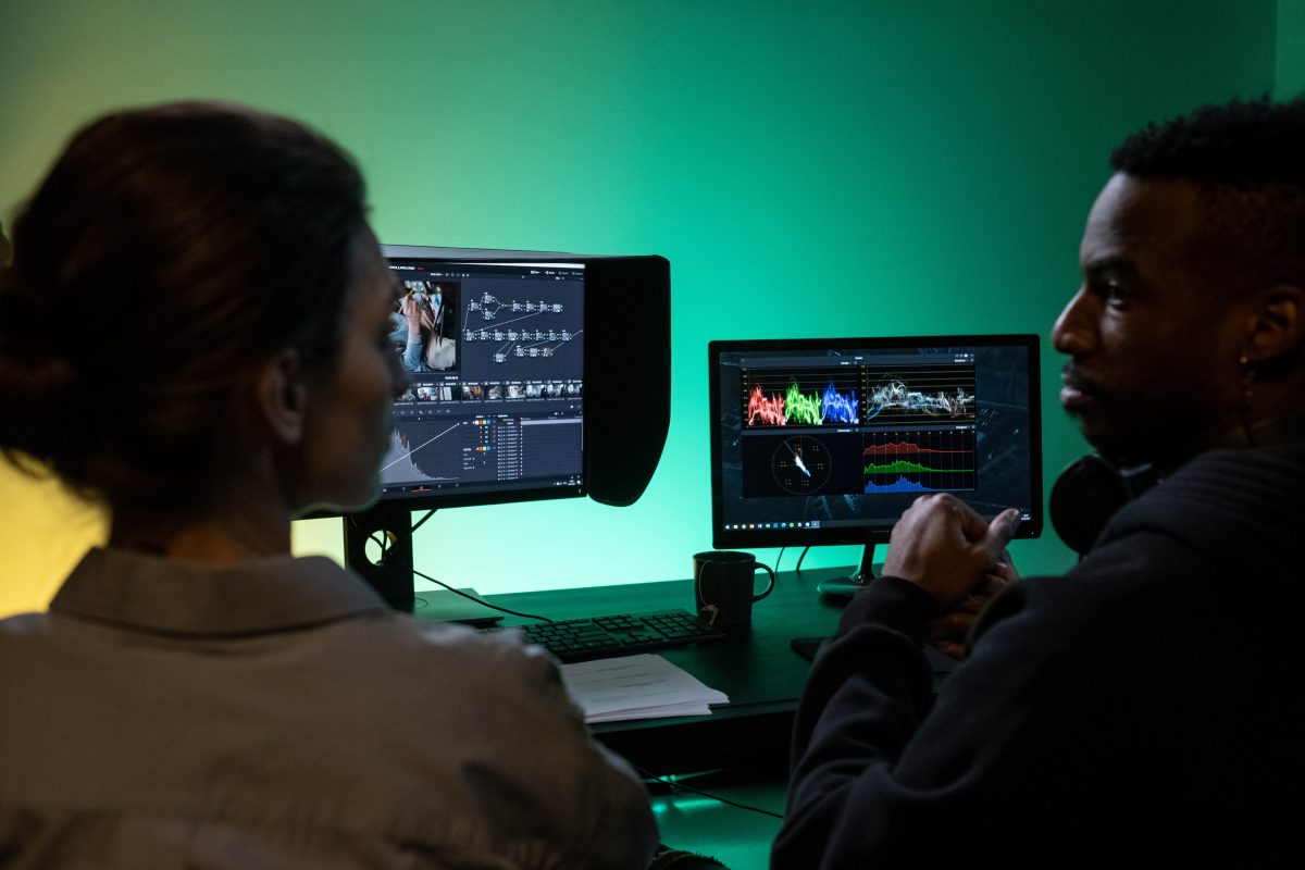 Image of a man and a woman in front of a monitor editing music. Source: pexels