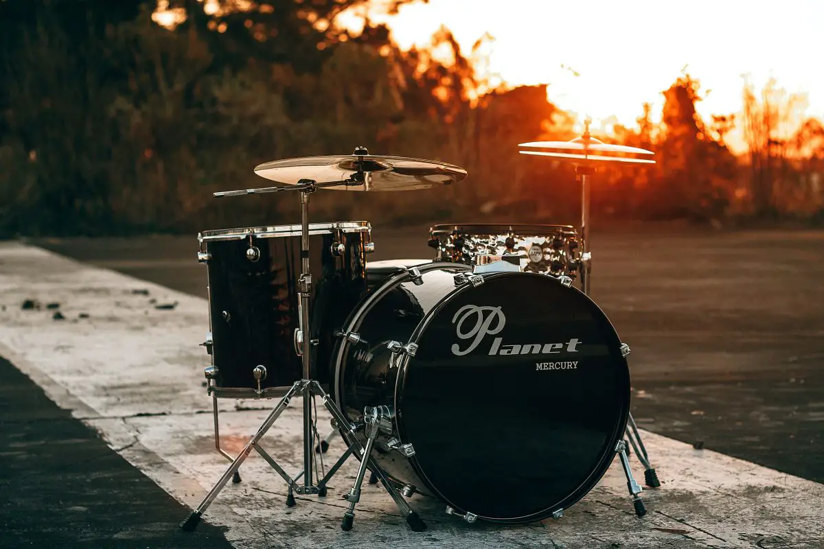 Image of a planet drum kit on the ground during sunset. Source: unsplash