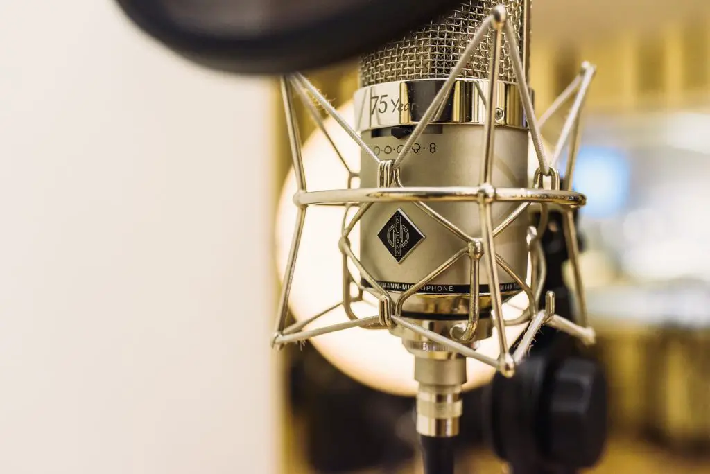 Image of a silver and black microphone with a stand. Source: Unsplash