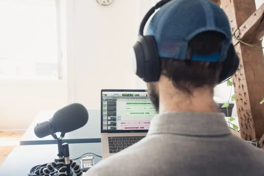 Image of a man listening to an audio recording with headphones on. Source: unsplash