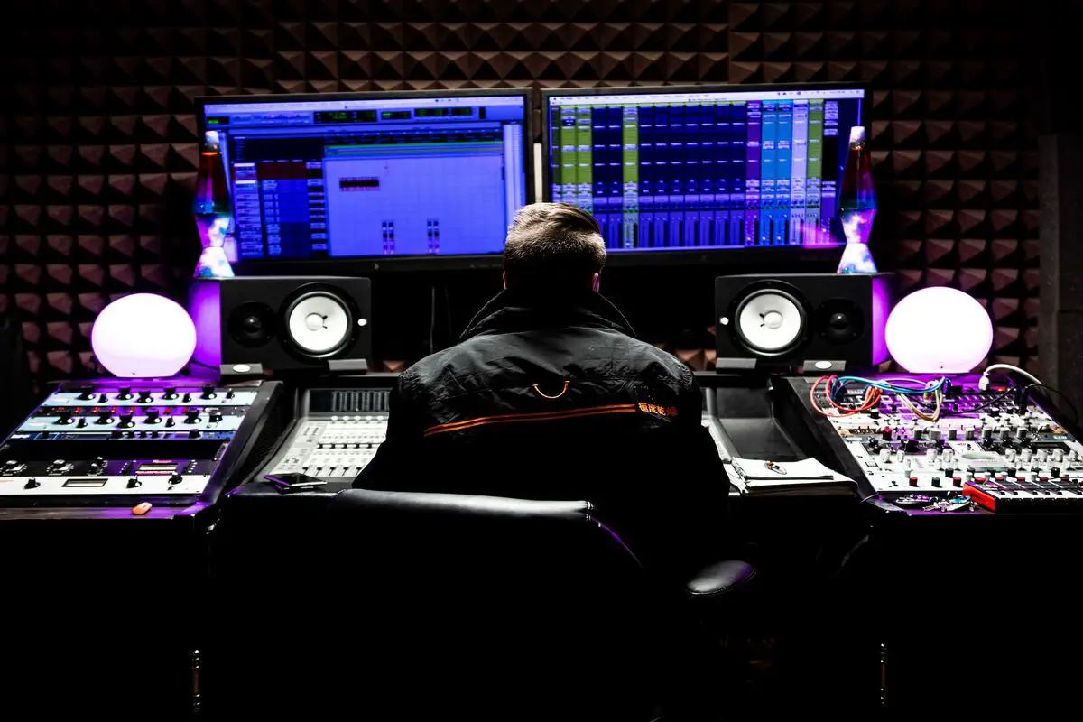 Image of a music producer in a studio. Source: unsplash