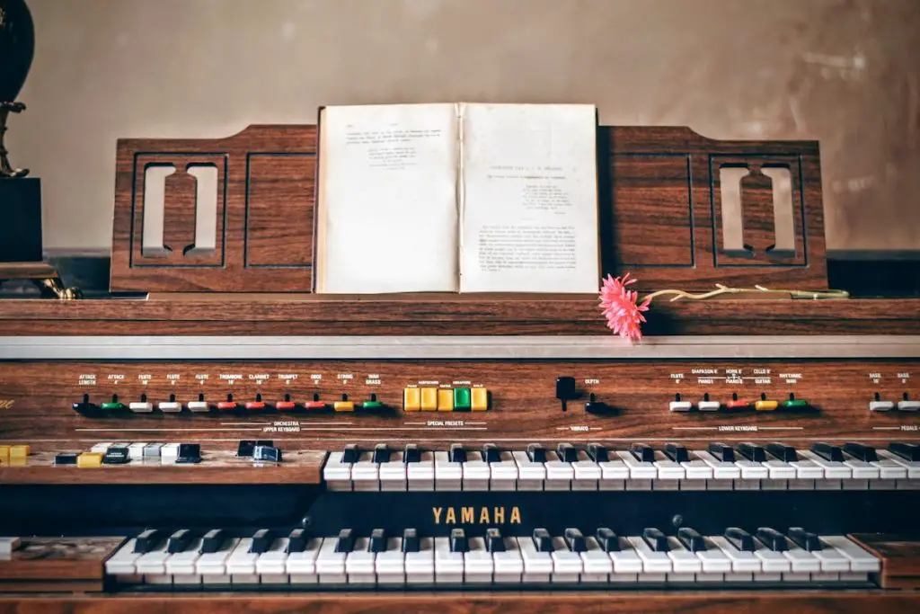 Image of a pipe organ with music sheets. Source: pexels