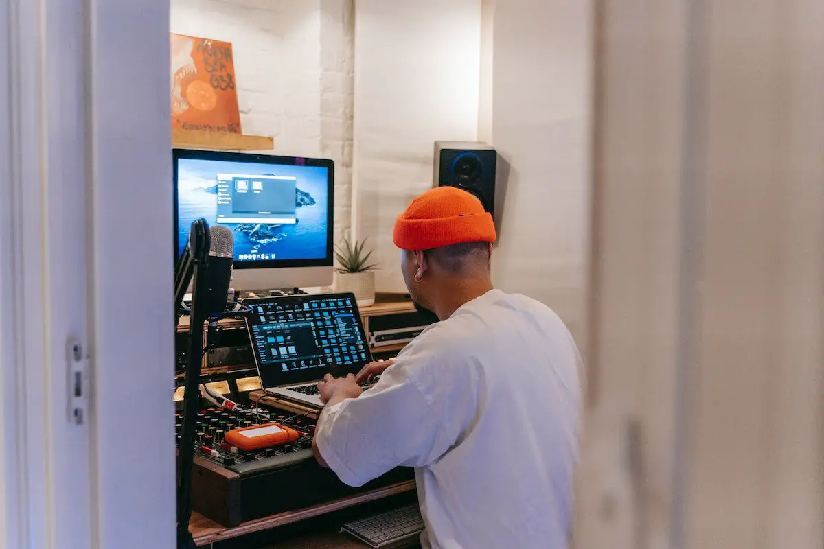Image of a producer in a music studio. Source: pexels