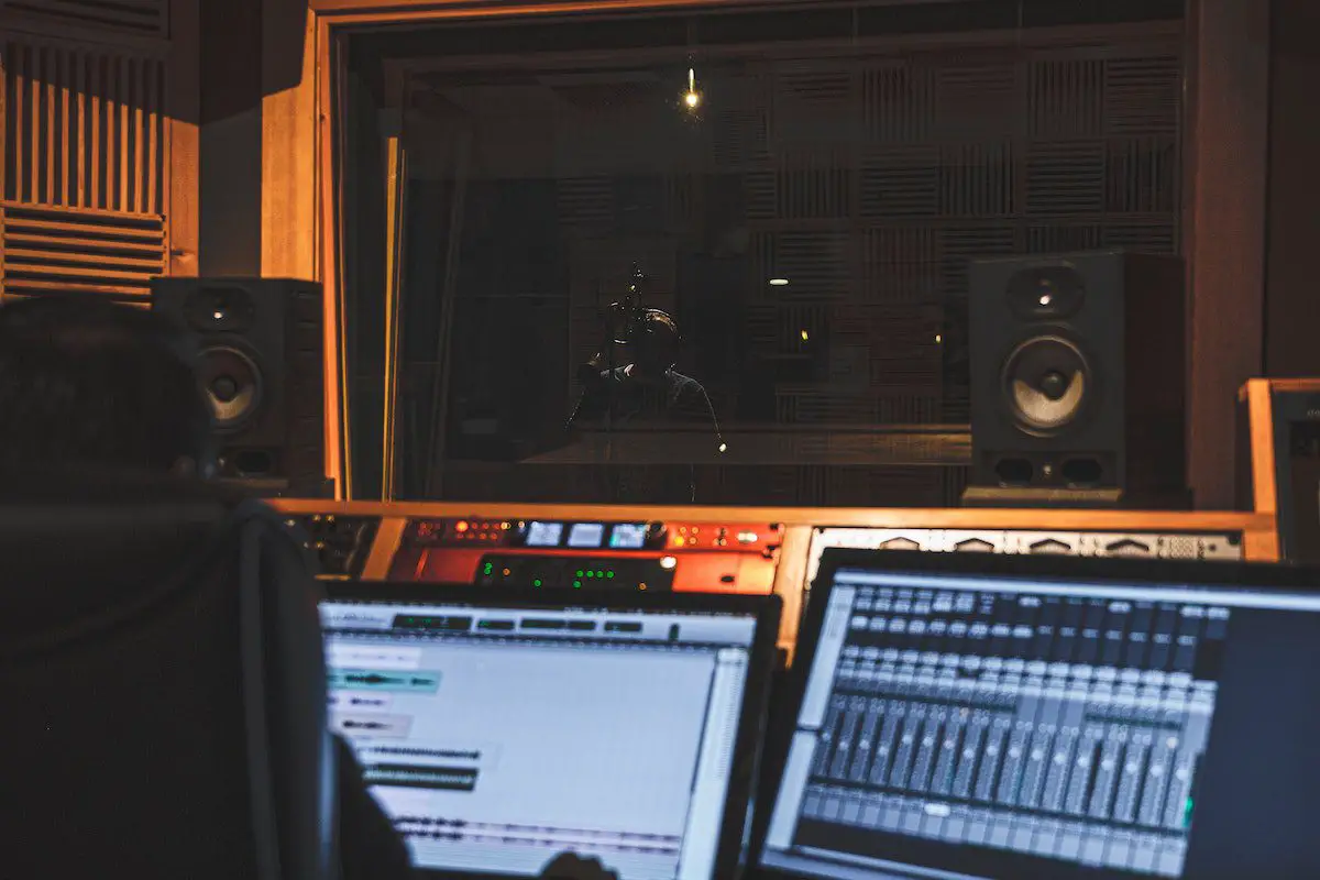 Image of a sound engineer working inside a recording studio. Source: pexels