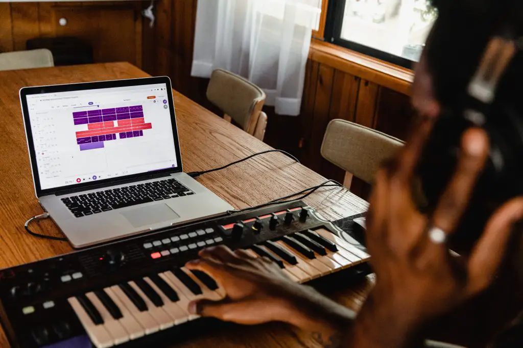 Man recording music with his laptop. Source: Unsplash