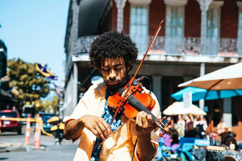 Man playing violin on the street. Source: unsplash