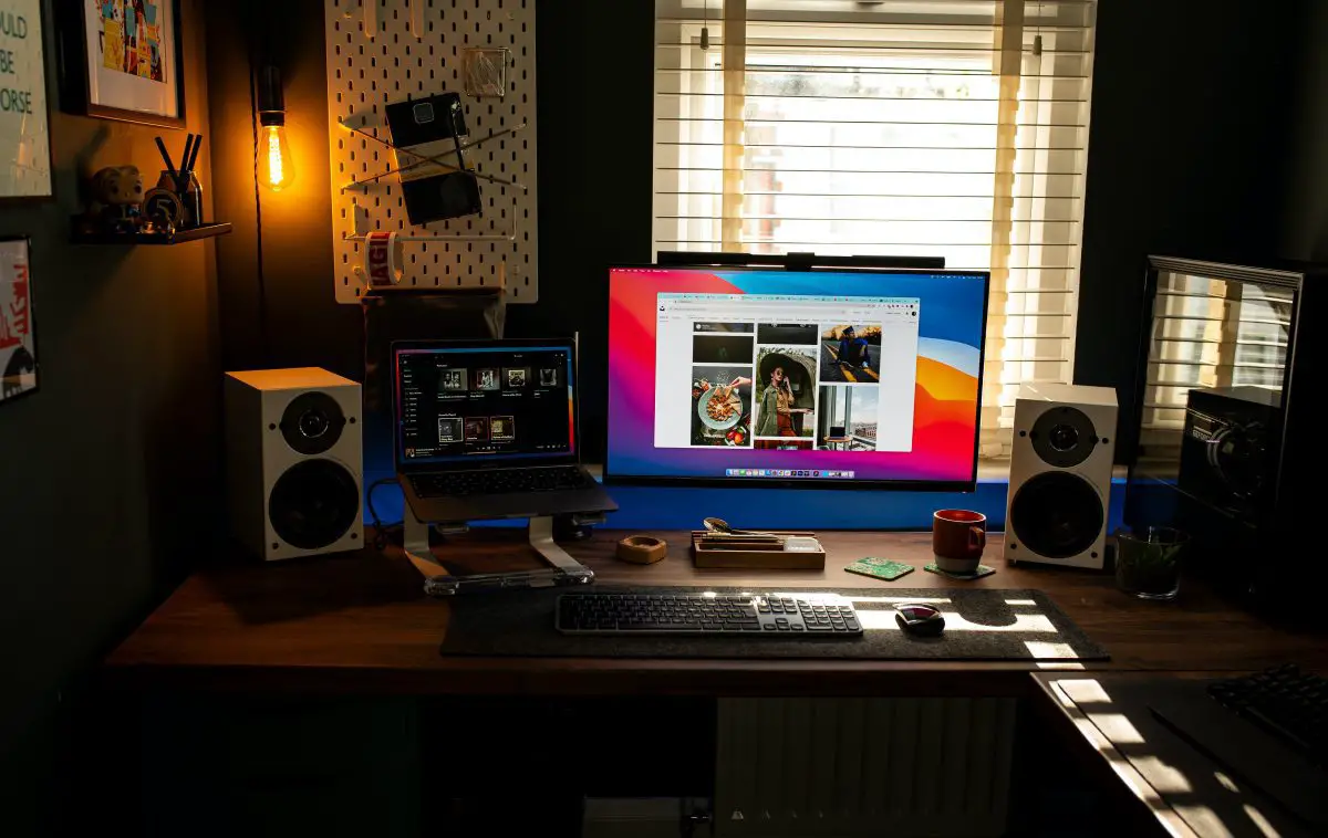 Image of a home studio with desktop laptop and speakers.