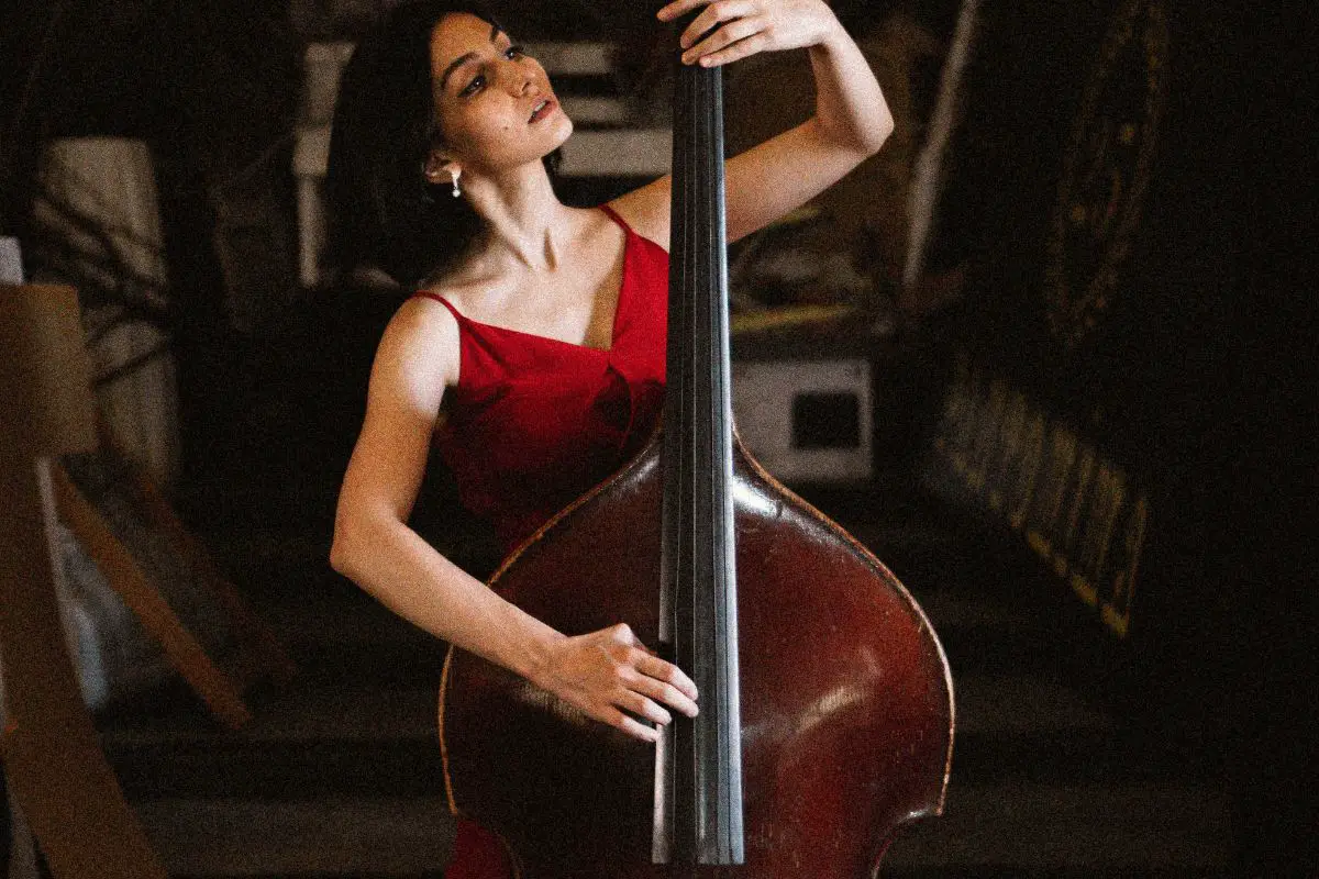 Image of a woman wearing a red dress playing an upright bass.