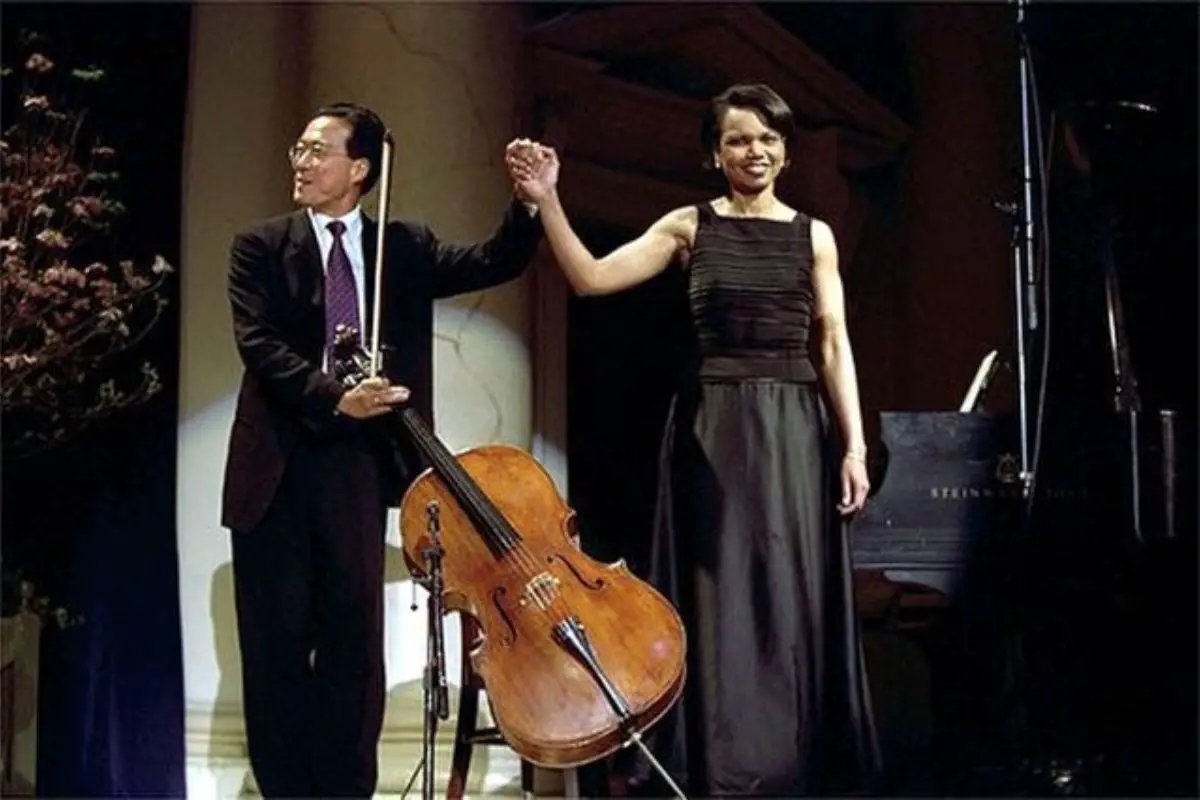 Image of cellist yo-yo ma with a woman taking their bow after performing.