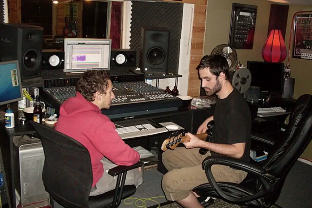 Image of two men in a recording studio.