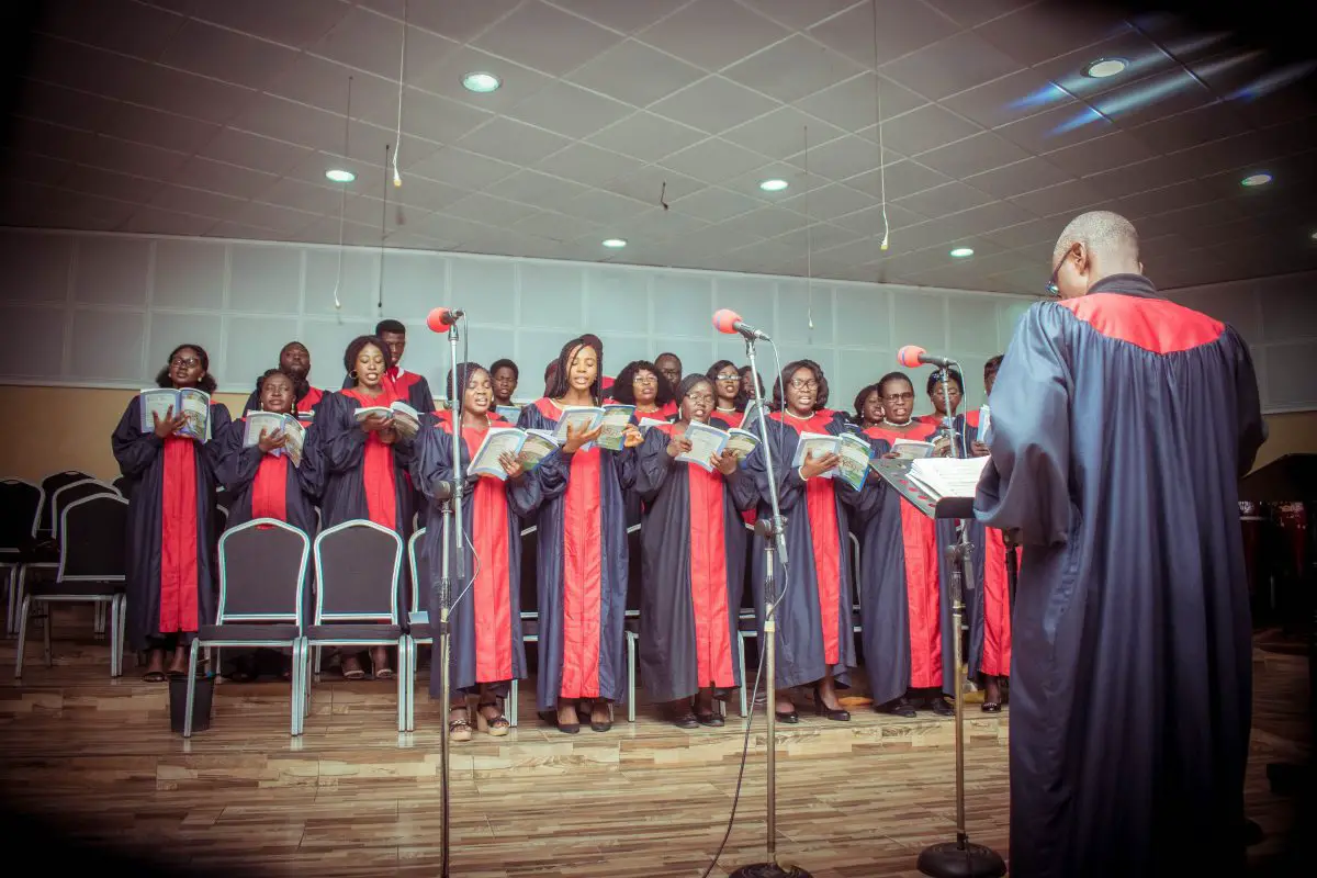 A church choir performing with a conductor. Source: unsplash