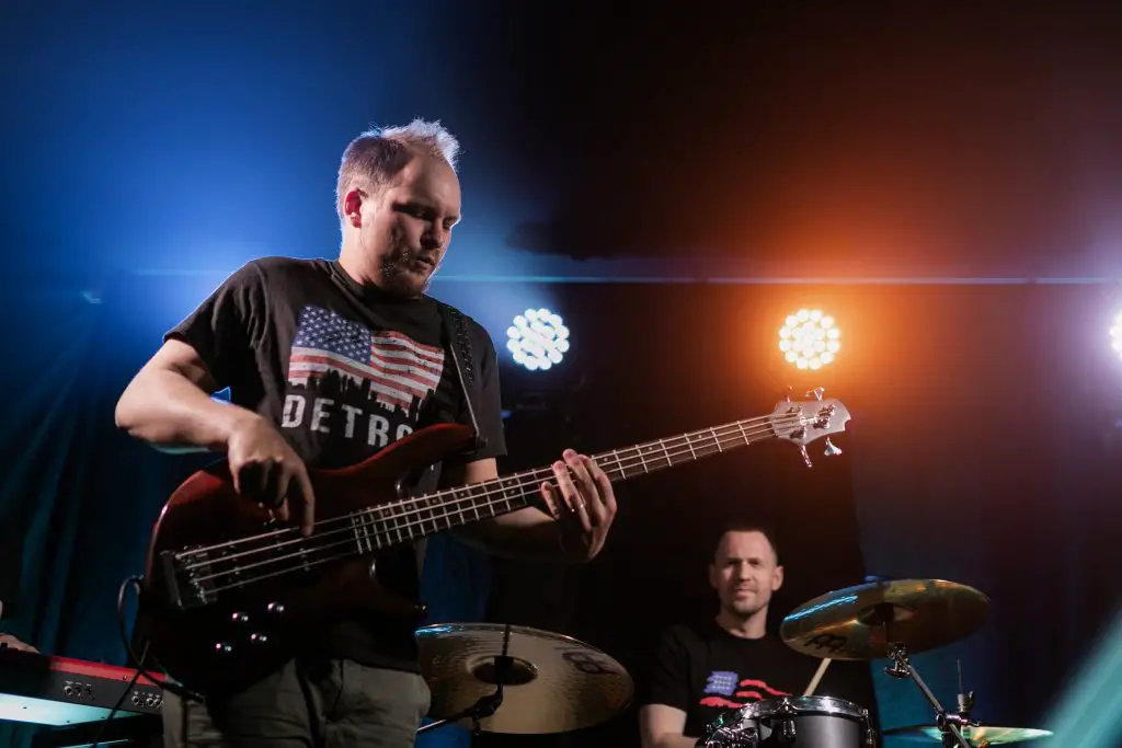 A bassist and a drummer on stage. Source: pexels