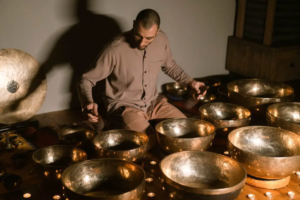 A man playing tibetan singing bowls. Source: pexels