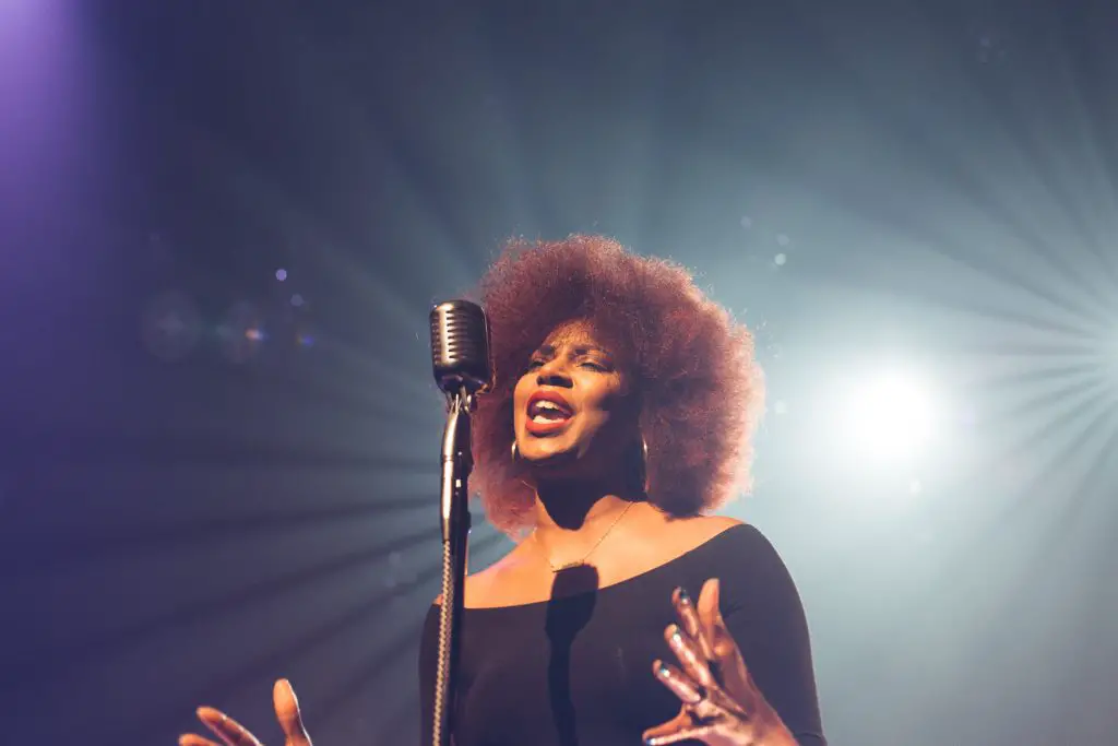 A woman singing on stage. Source: unsplash