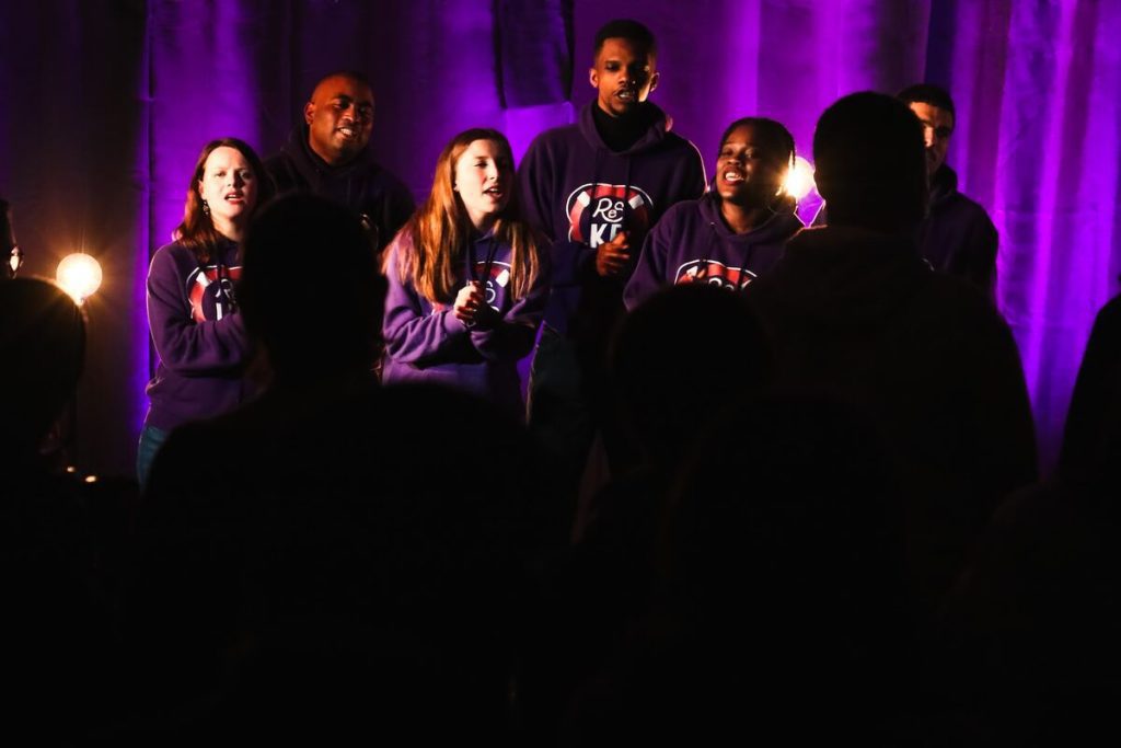 Image of an a capella group performing live. Source: unsplash