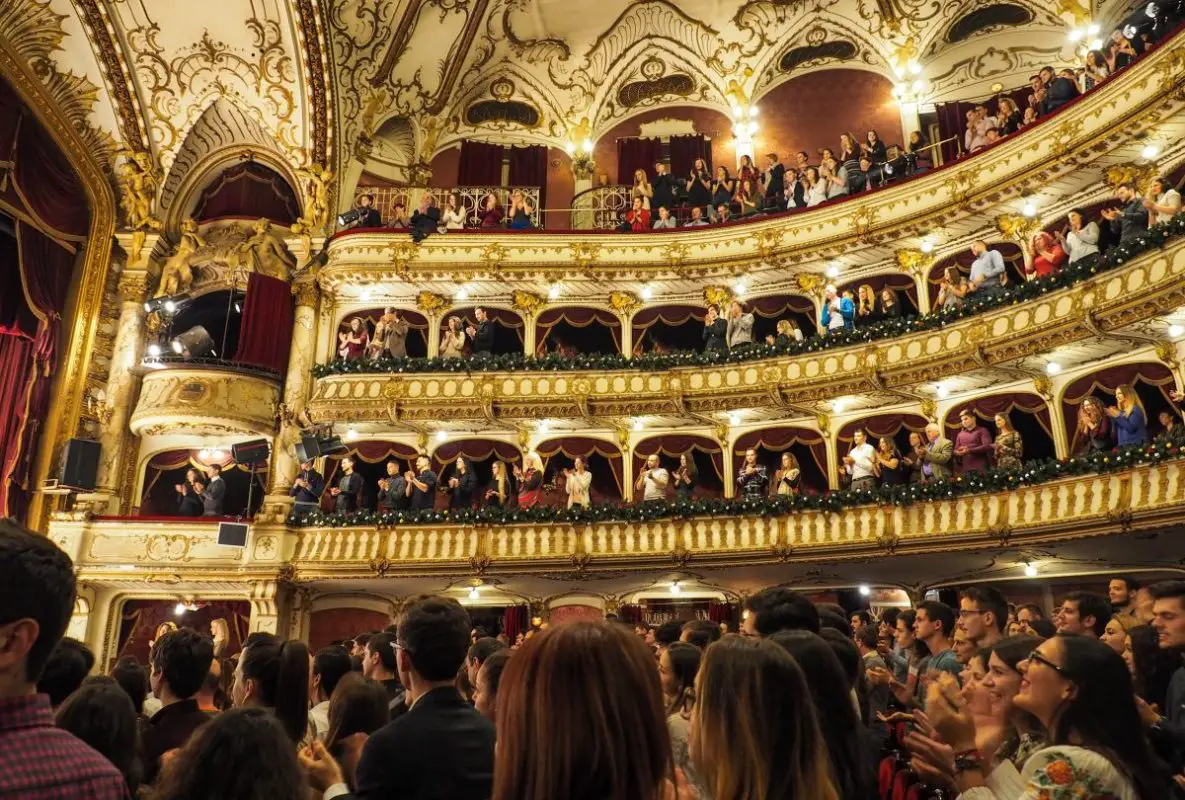 Audience in a standing ovation for a theater performance. Source: unsplash