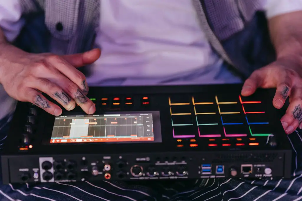 Close up of a person using a midi sequencer. Source: pexels
