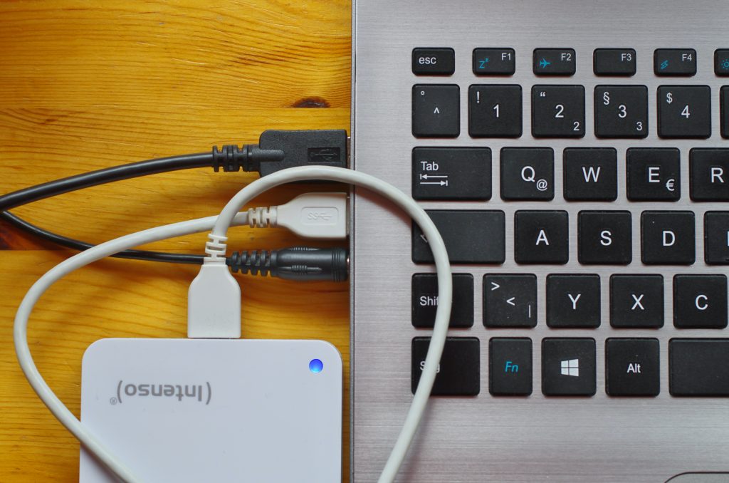 Closeup of a computers usb ports with cables connected. Source: unsplash