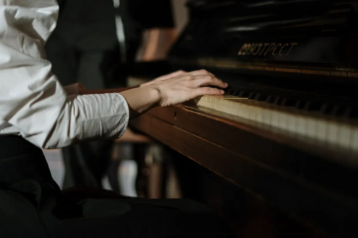 Closeup of a pianist playing the piano. Source: pexels