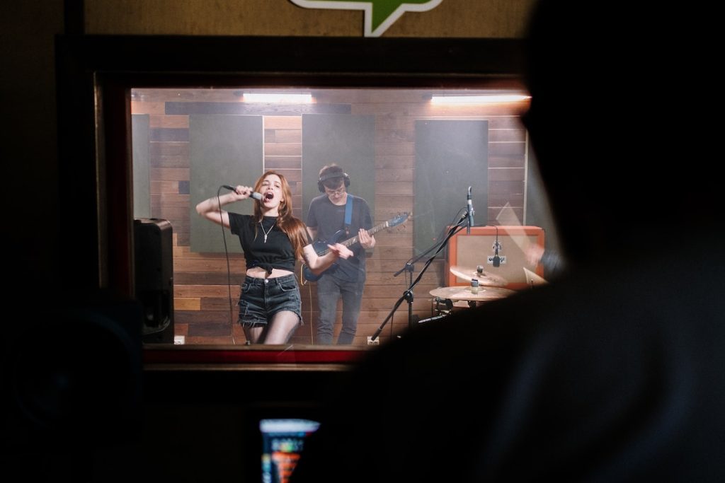 Image of a band recording in a studio. Source: pexels