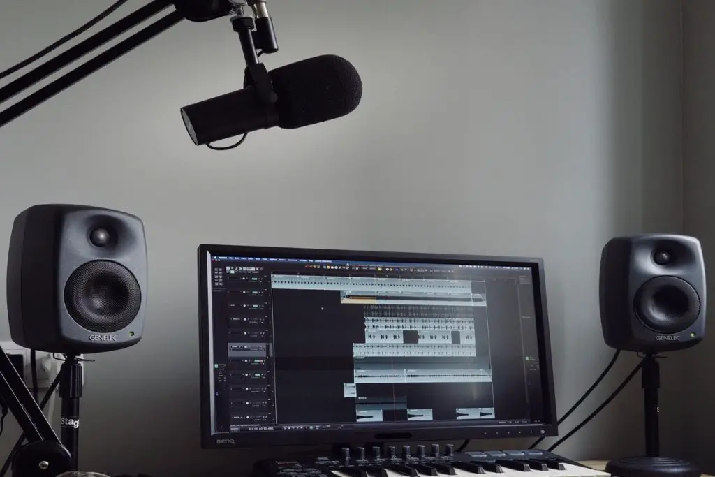 Image of a home studio with studio monitors and a microphone as transducers. Source: unsplash