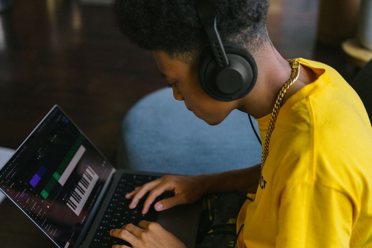 Image of a man making music with a digital keyboard. Source: unsplash